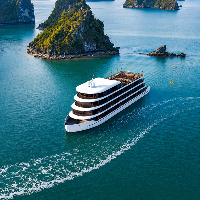 Luxury Cycad Legacy Cruise ship sailing near green islands
